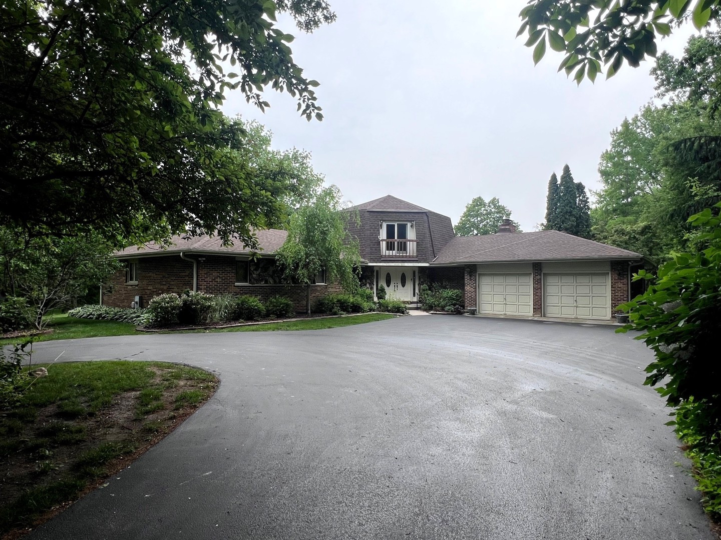 a front view of a house with a garden and porch