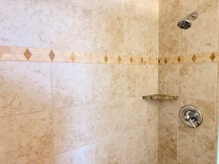 a bathroom with shower and a shower