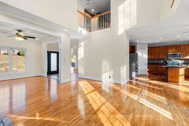 a large kitchen with stainless steel appliances granite countertop a stove a sink a refrigerator and a granite counter tops