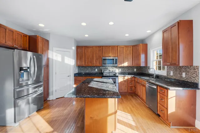 a kitchen with granite countertop a stove and a sink