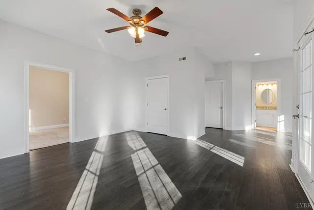 a bathroom with a granite countertop sink a toilet and a mirror