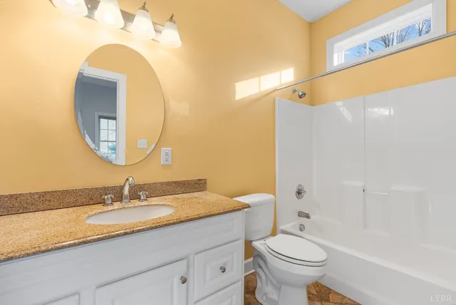 an empty room with a ceiling fan and a window