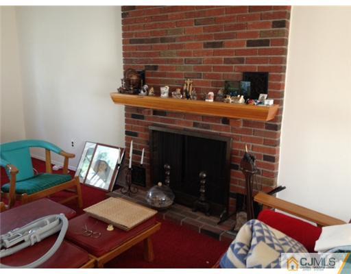 19 Highpoint Drive Edison, NJ 08820 - Photo 5 of 8 a living room with furniture and a fireplace
