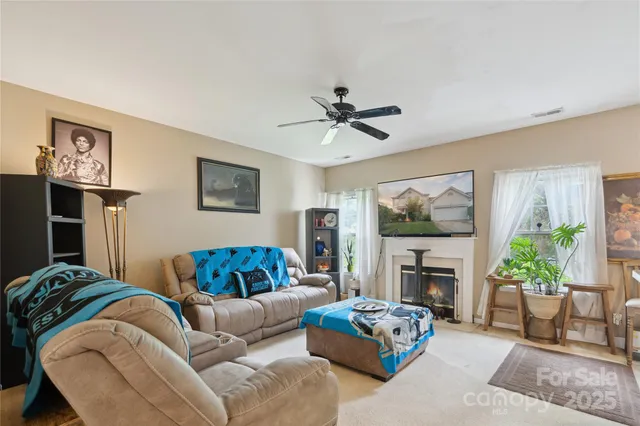 a living room with furniture a window and a fireplace