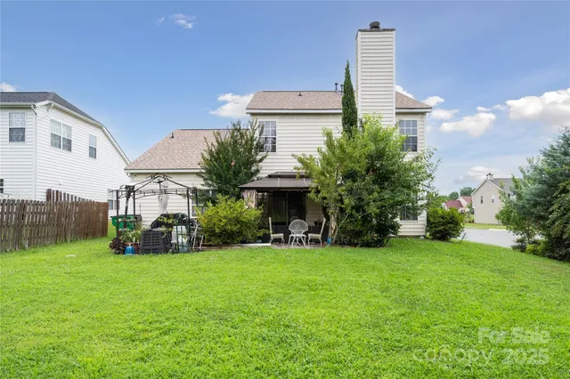 a view of a house with a yard and sitting area