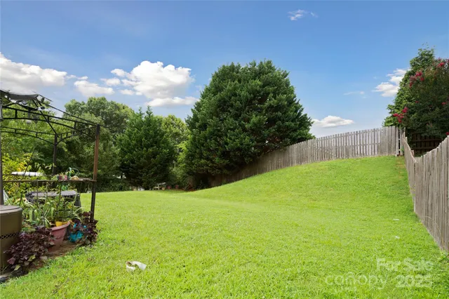 a view of yard with swimming pool and green space