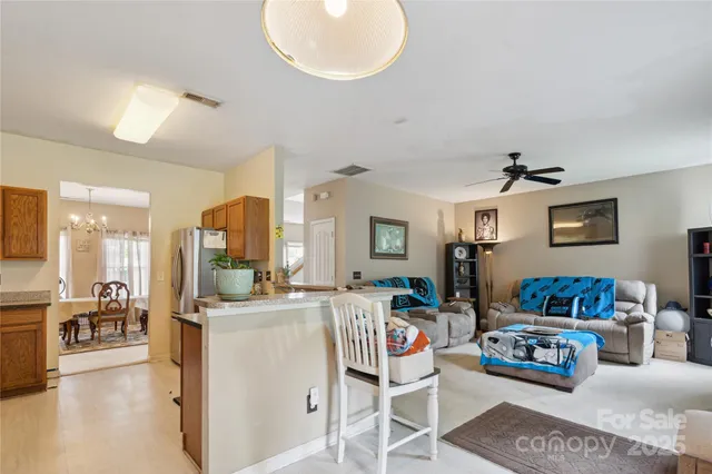 a living room with kitchen island furniture and a wooden floor