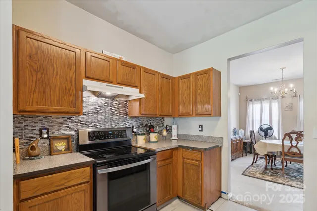 a kitchen with stainless steel appliances a stove sink and cabinets