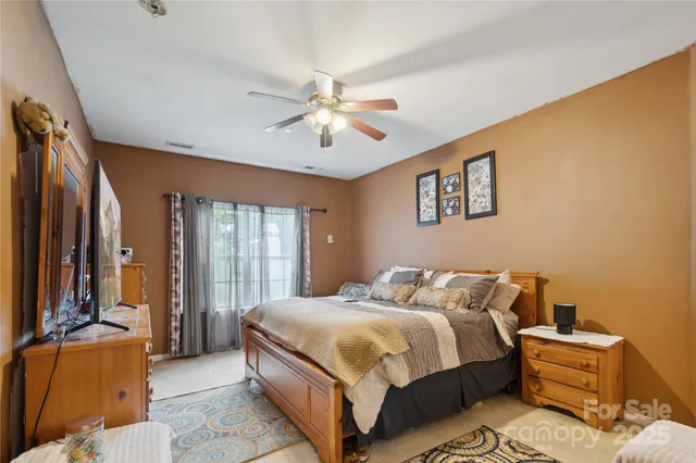 a bedroom with a bed couch and a window