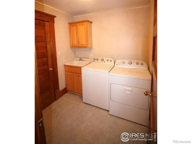 a kitchen with stainless steel appliances granite countertop a sink and cabinets with wooden floor