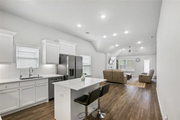 a kitchen with sink cabinets and wooden floor