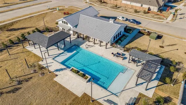 an aerial view of a house with pool table and chairs