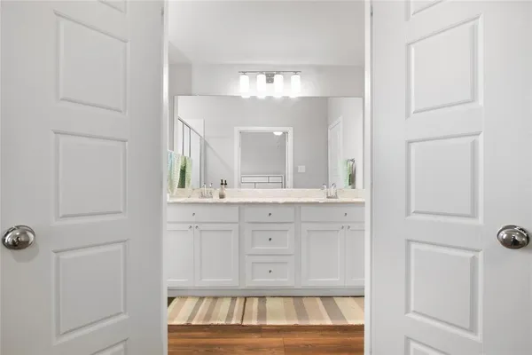 a bathroom with a sink vanity and mirror