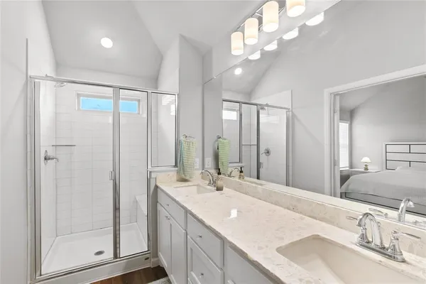 a bathroom with a sink double vanity and a mirror