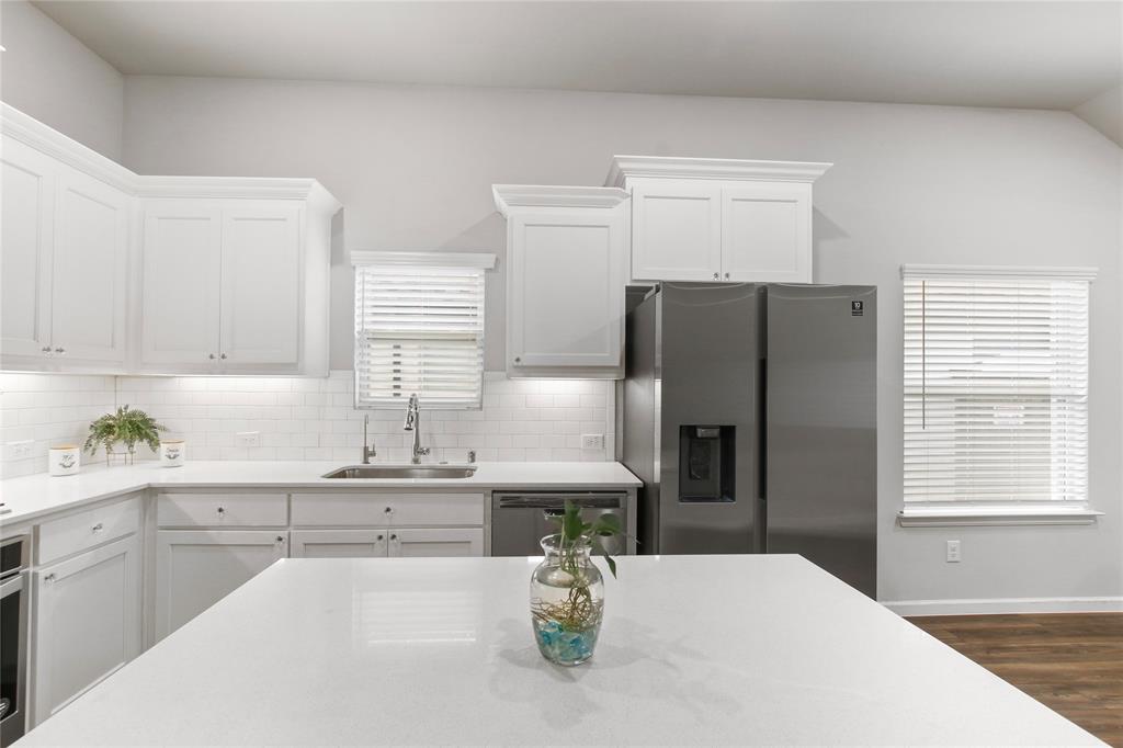 1613 Wayback Drive Celina, TX 75009 - Photo 8 of 35 a kitchen with stainless steel appliances a refrigerator sink and stove