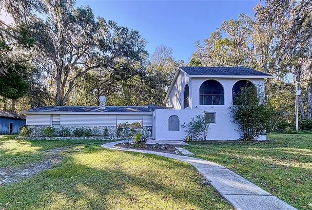 a kitchen with stainless steel appliances kitchen island granite countertop a sink and cabinets