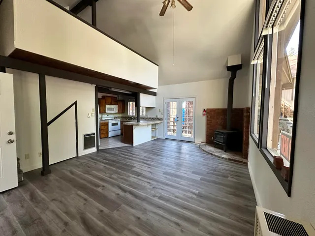 a view of a kitchen with a sink and a refrigerator