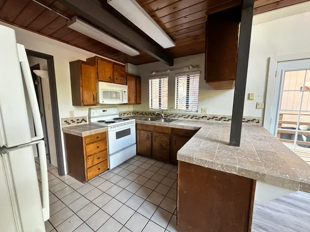 a kitchen with a sink stove and microwave