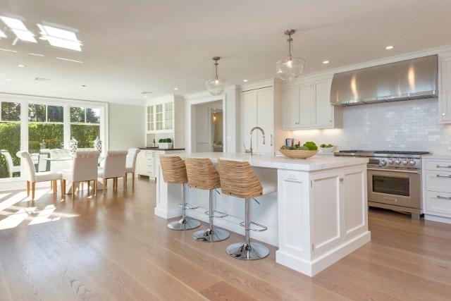 22 Point Road Norwalk, CT 06854 - Photo 7 of 24 a kitchen with stainless steel appliances granite countertop a stove top oven a sink dishwasher a dining table and chairs with wooden floor