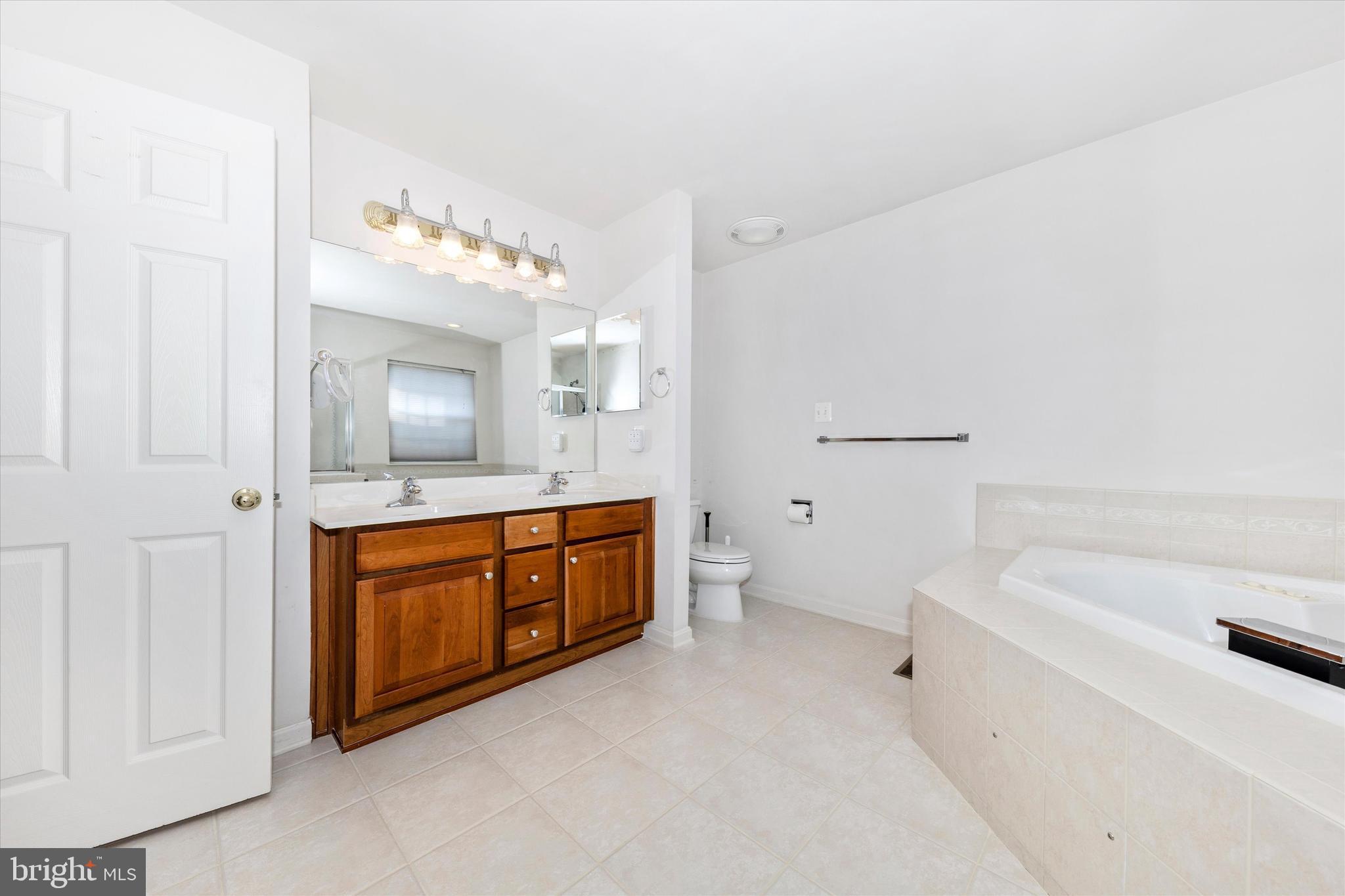 100 Sunlight Drive Frederick, MD 21702 - Photo 14 of 41 a spacious bathroom with a tub sink and mirror
