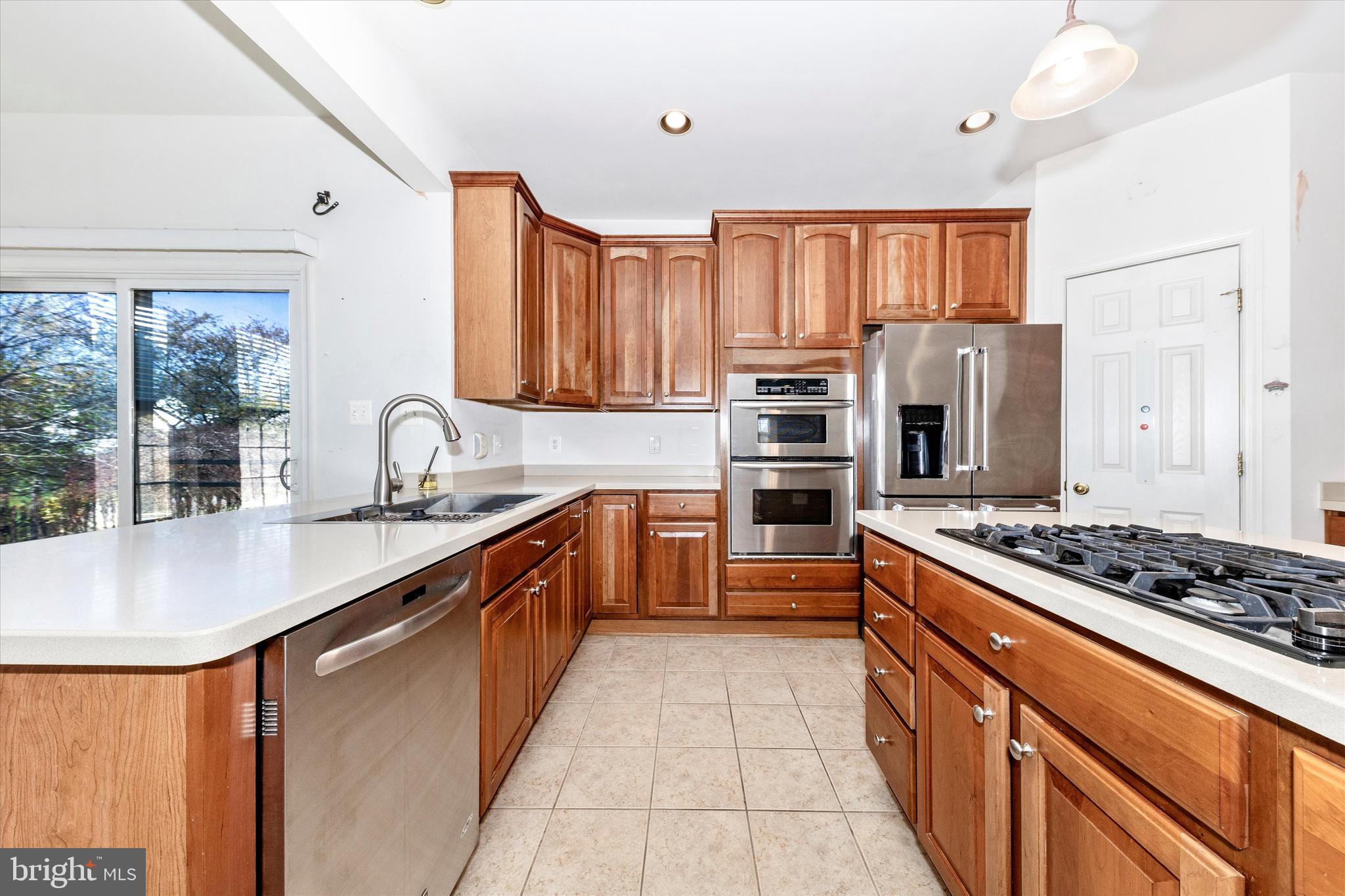 100 Sunlight Drive Frederick, MD 21702 - Photo 8 of 41 a kitchen with stainless steel appliances granite countertop a stove a sink dishwasher and a refrigerator