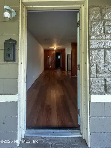a kitchen with a refrigerator and white cabinets
