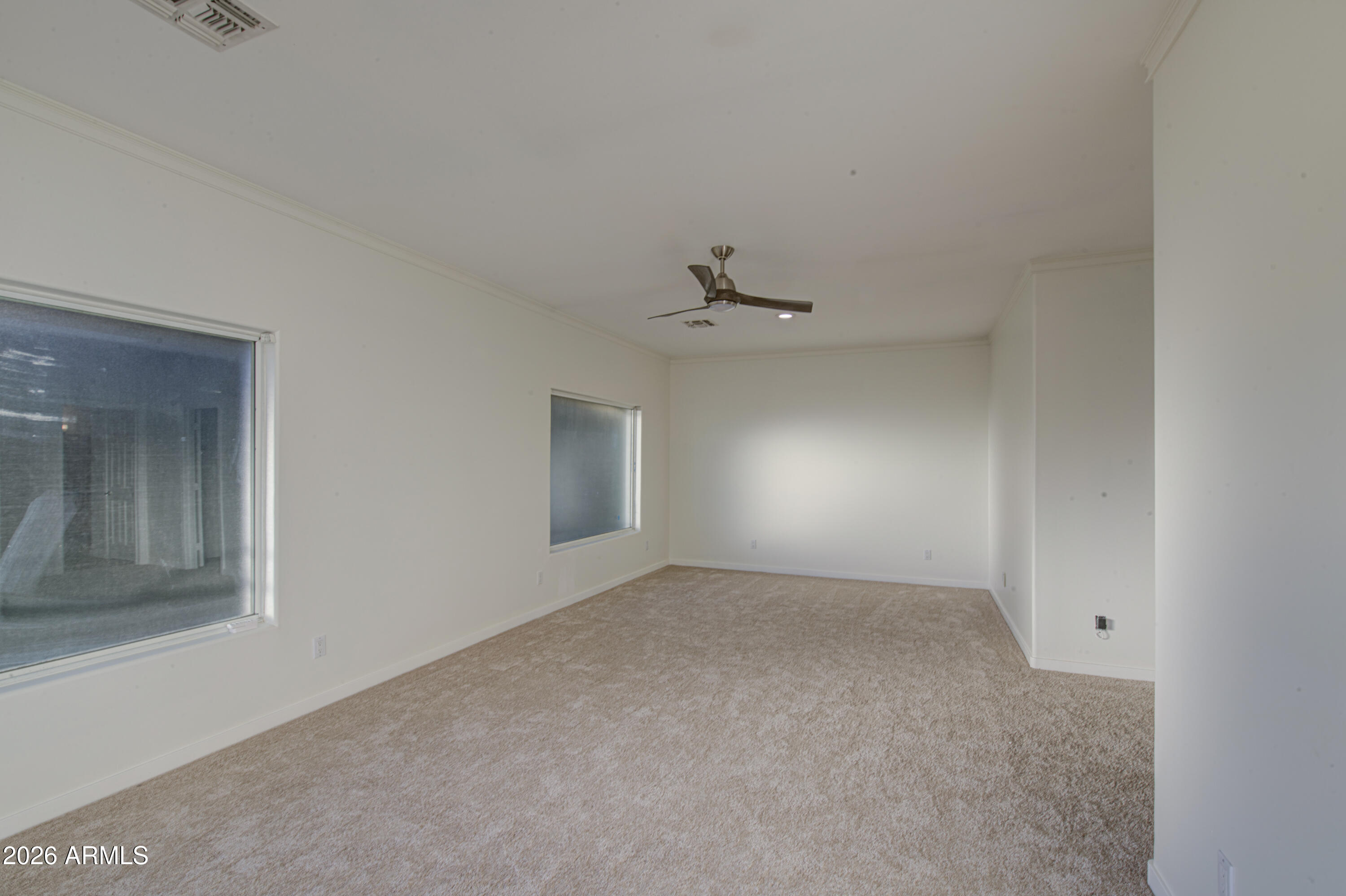 6018 North 5th Place Phoenix, AZ 85014 - Photo 25 of 53 an empty room with a ceiling fan and windows