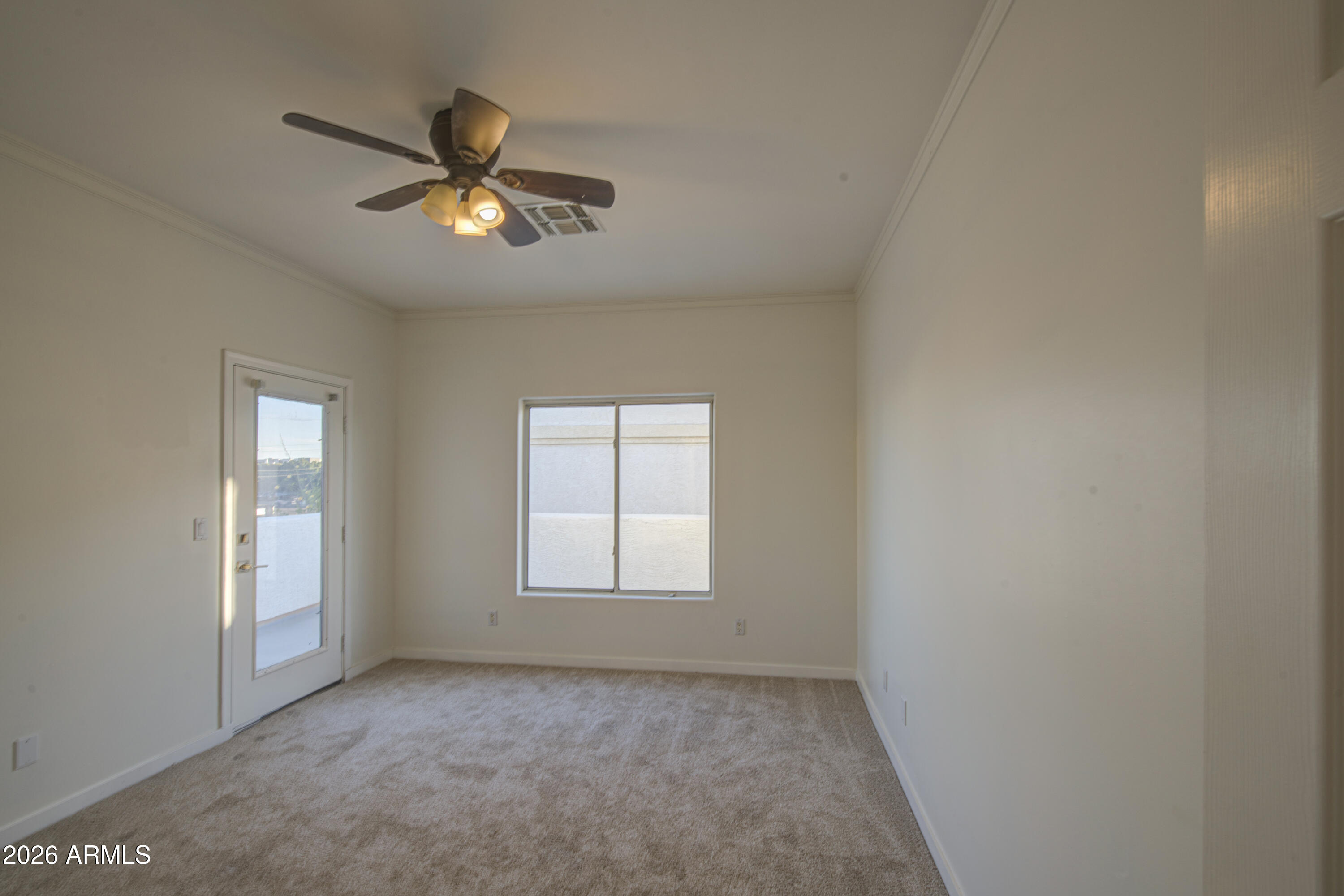 6018 North 5th Place Phoenix, AZ 85014 - Photo 30 of 53 an empty room with a window and a fan