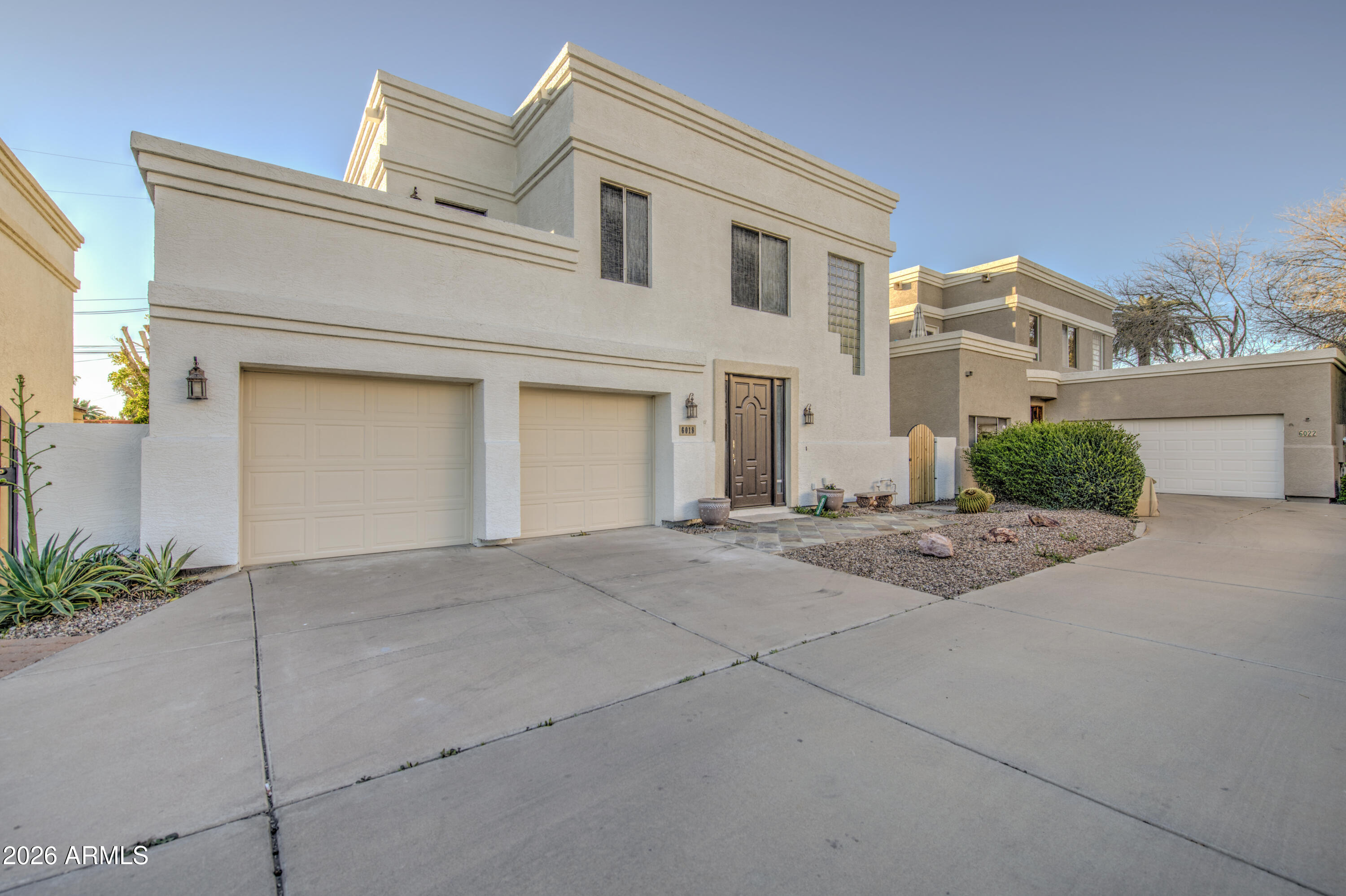 6018 North 5th Place Phoenix, AZ 85014 - Photo 3 of 53 a view of a white house with a yard and garage