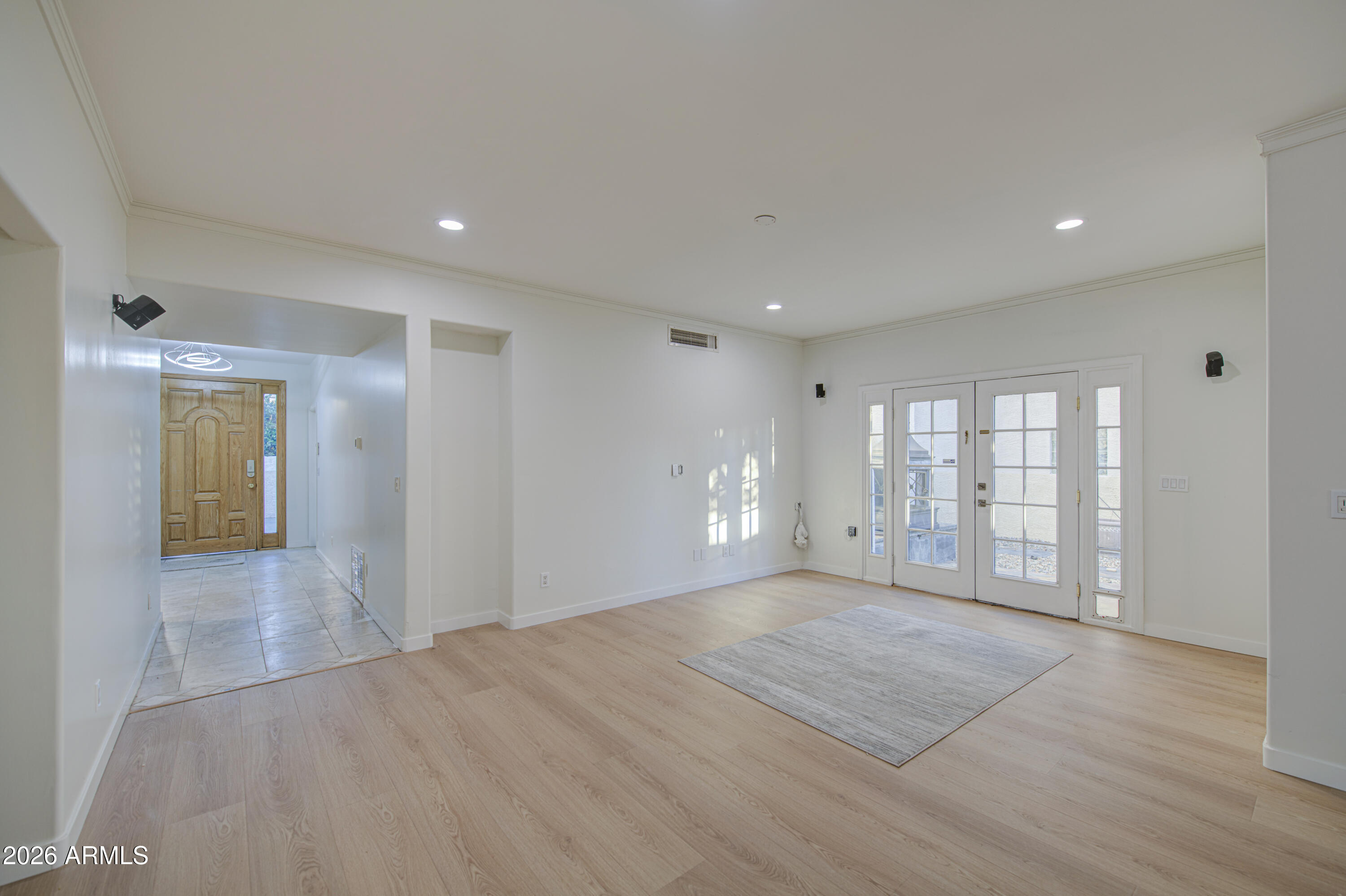 6018 North 5th Place Phoenix, AZ 85014 - Photo 8 of 53 a view of an empty room with wooden floor and a window
