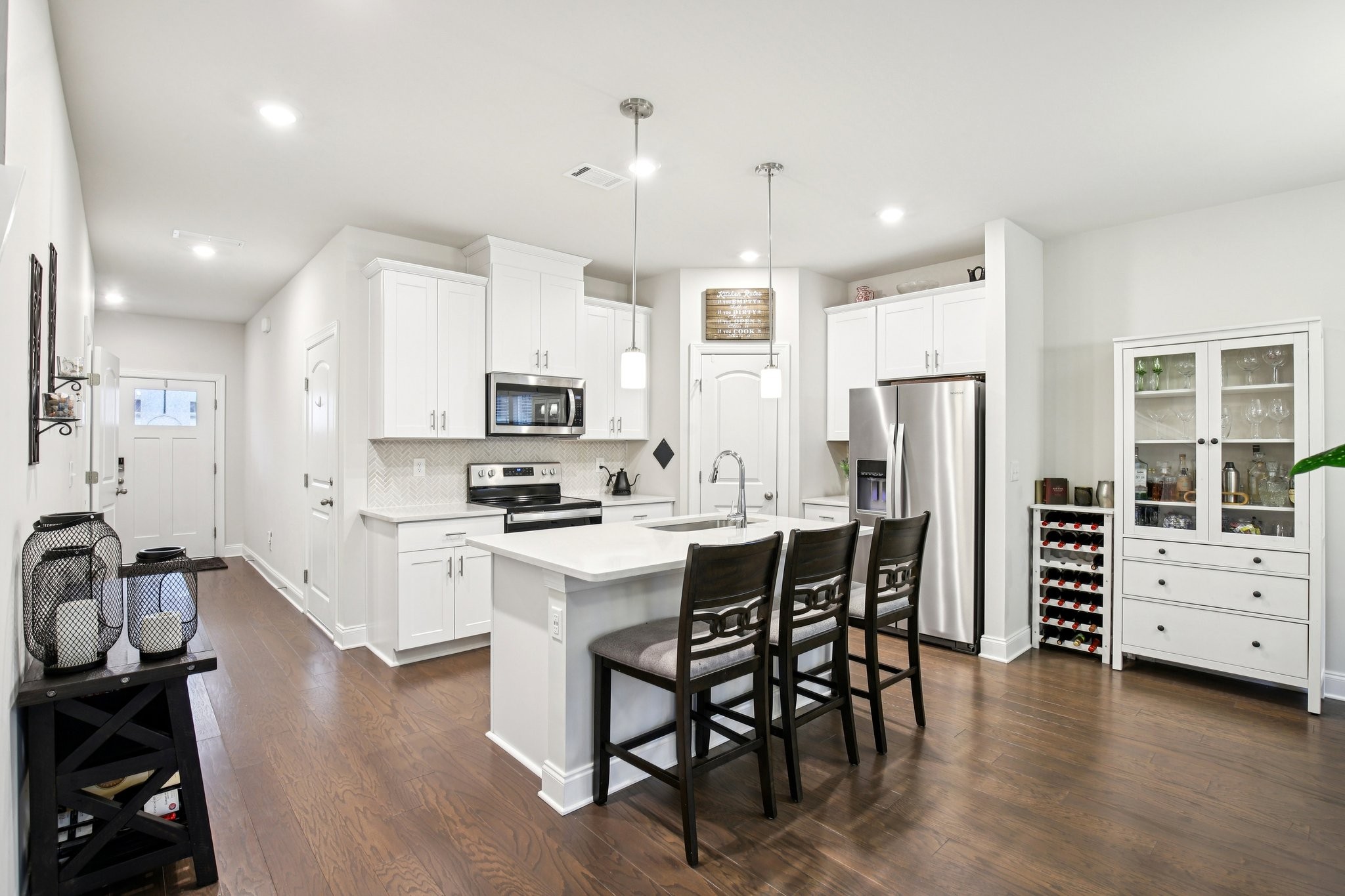 4657 Ridge Bend Drive Nashville, TN 37207 - Photo 8 of 21 a kitchen with stainless steel appliances a stove a sink a refrigerator cabinets and wooden floor