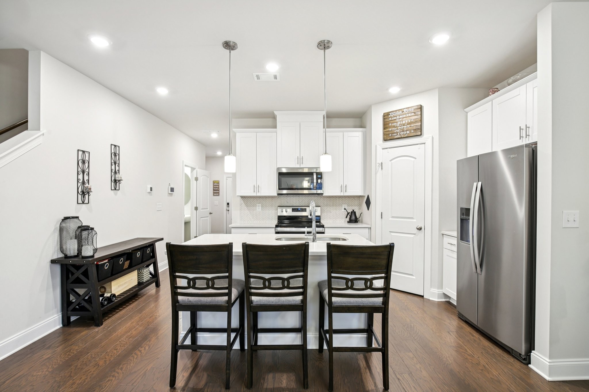 4657 Ridge Bend Drive Nashville, TN 37207 - Photo 9 of 21 a kitchen with stainless steel appliances a dining table chairs stove refrigerator and cabinets
