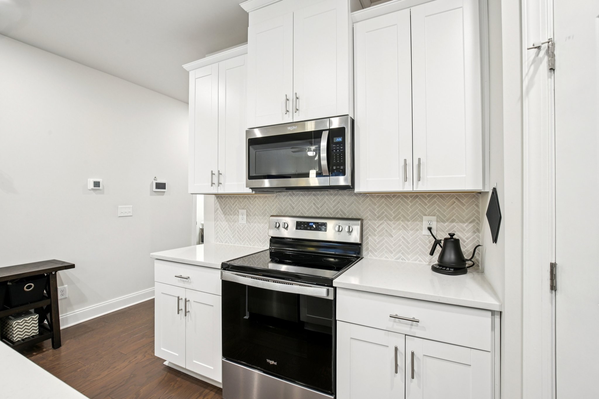 4657 Ridge Bend Drive Nashville, TN 37207 - Photo 10 of 21 a kitchen with stainless steel appliances a stove a microwave and cabinets