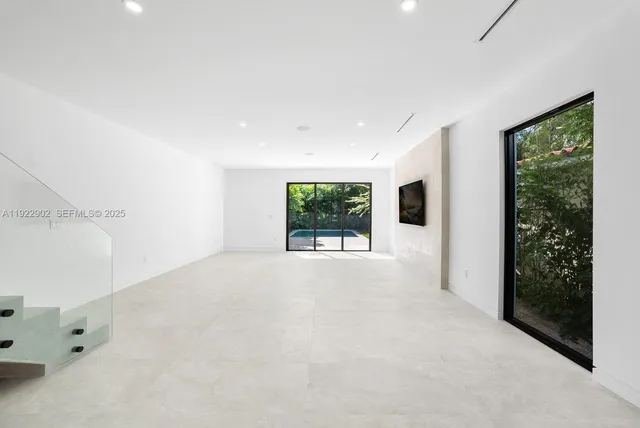a view of a room with a window and ceiling fan