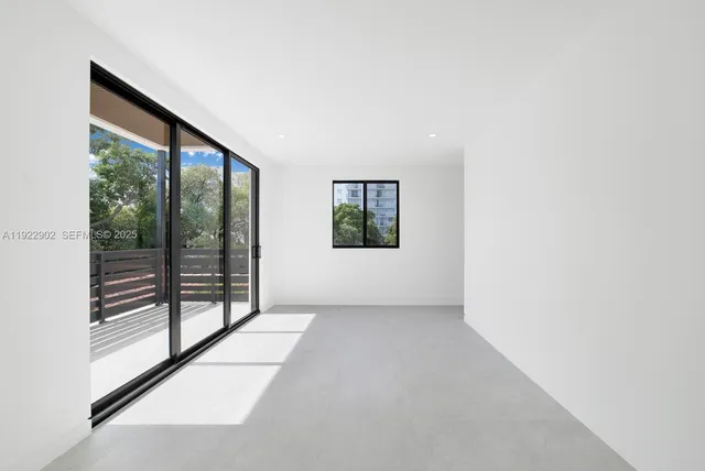 an empty room with windows and closet