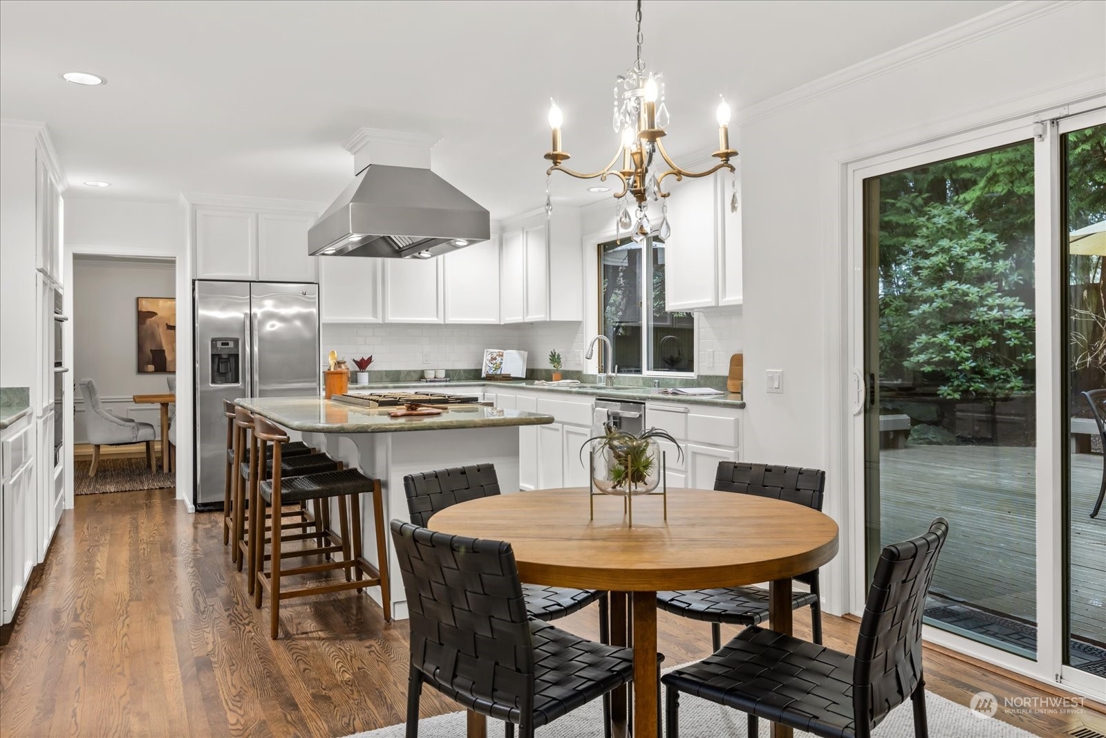 8418 192nd Street Southwest Edmonds, WA 98026 - Photo 13 of 39 a kitchen with a dining table chairs stainless steel appliances and cabinets