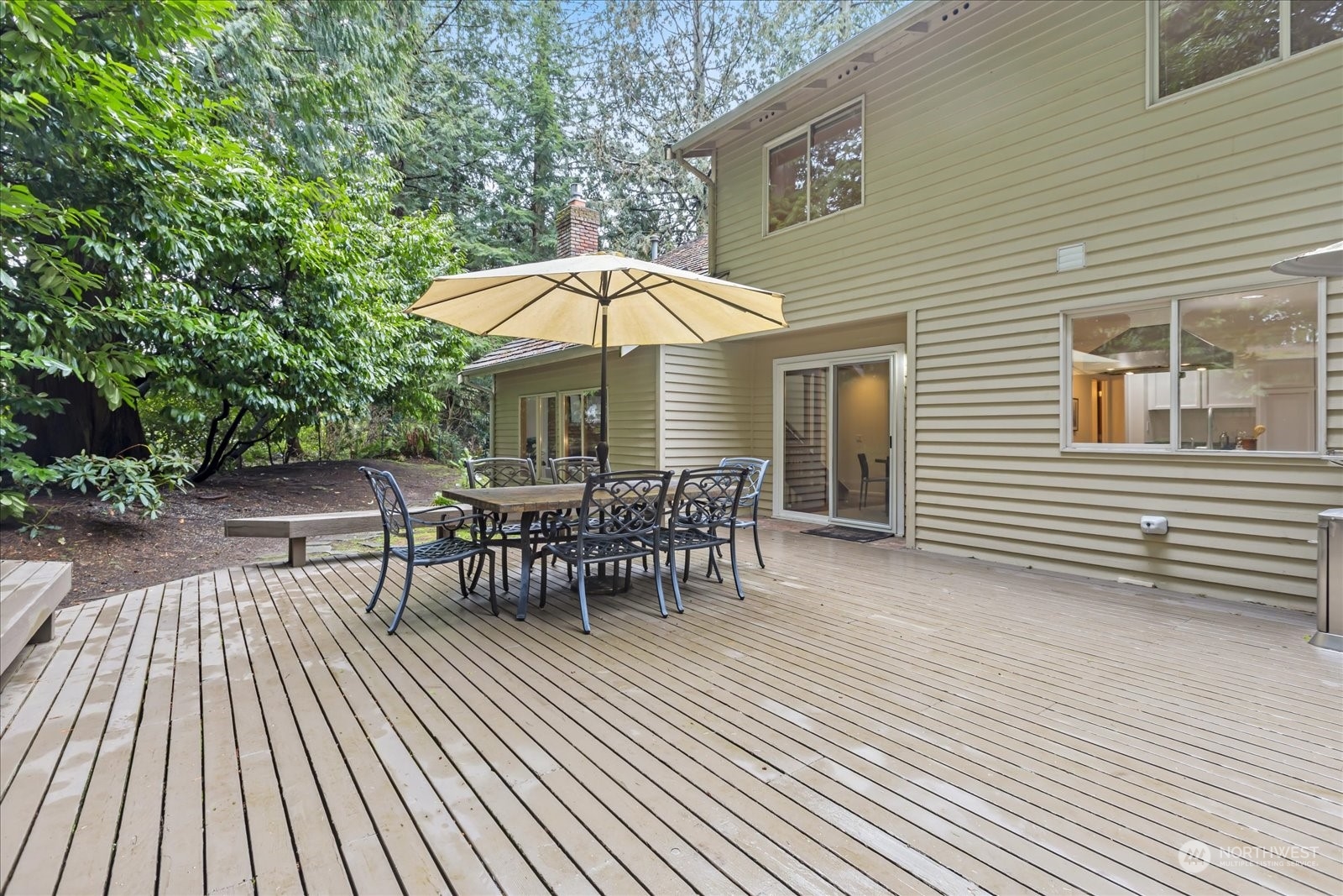 8418 192nd Street Southwest Edmonds, WA 98026 - Photo 28 of 39 a view of a roof deck with table and chairs under an umbrella with wooden floor