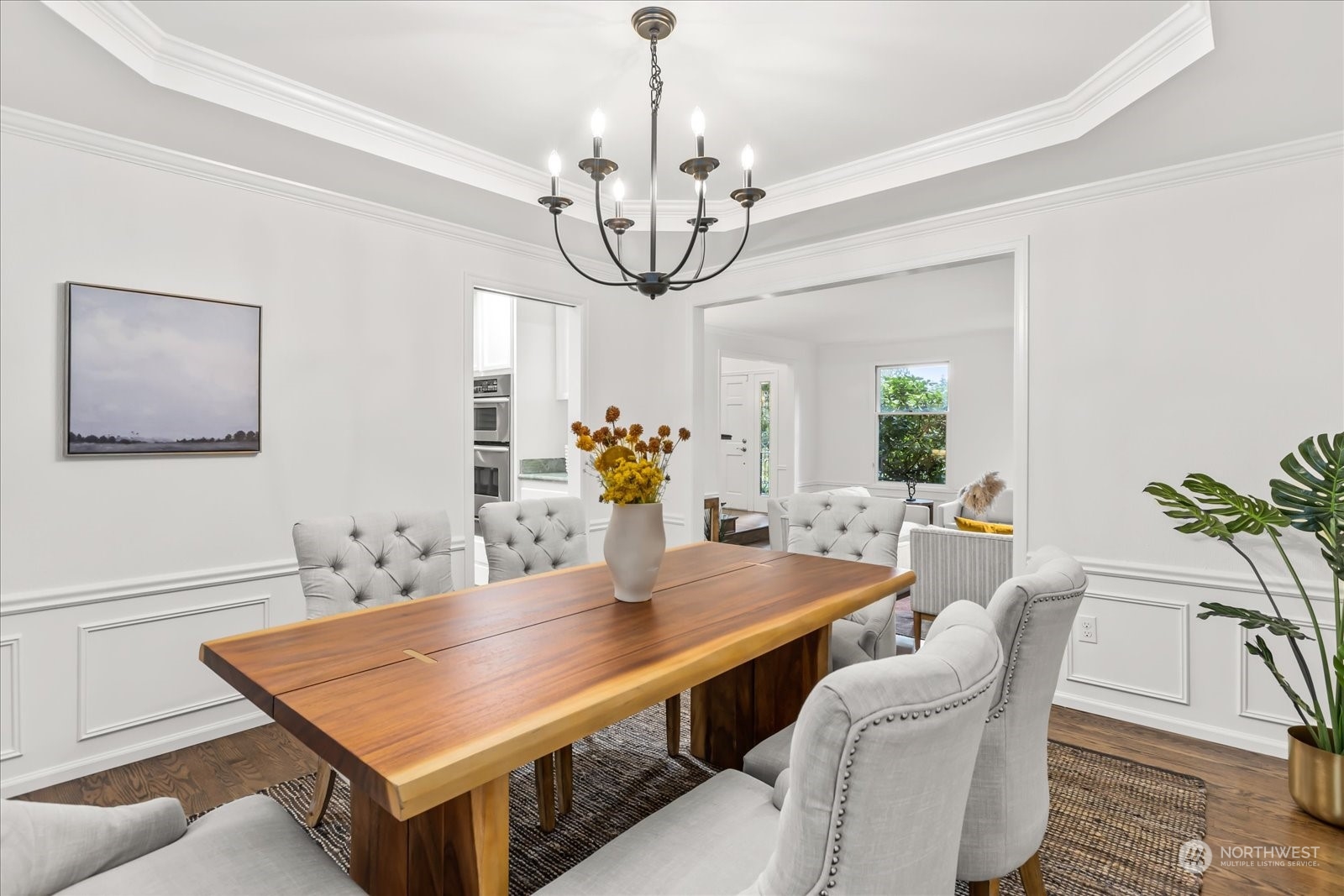 8418 192nd Street Southwest Edmonds, WA 98026 - Photo 8 of 39 a dining room with wooden floor a chandelier a wooden table and chairs