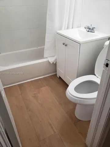 a white toilet sitting next to a bathroom sink