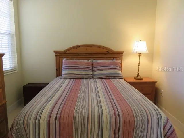 a bedroom with a bed and a lamp