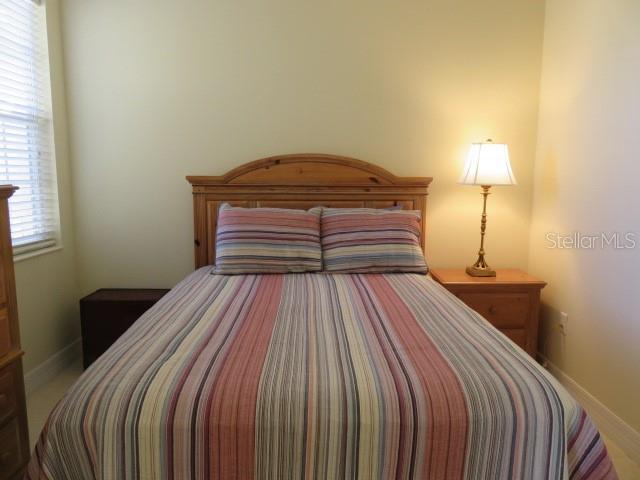 9720 Sea Turtle Terrace, Unit 201 Bradenton, FL 34212 - Photo 11 of 29 a bedroom with a bed and a lamp