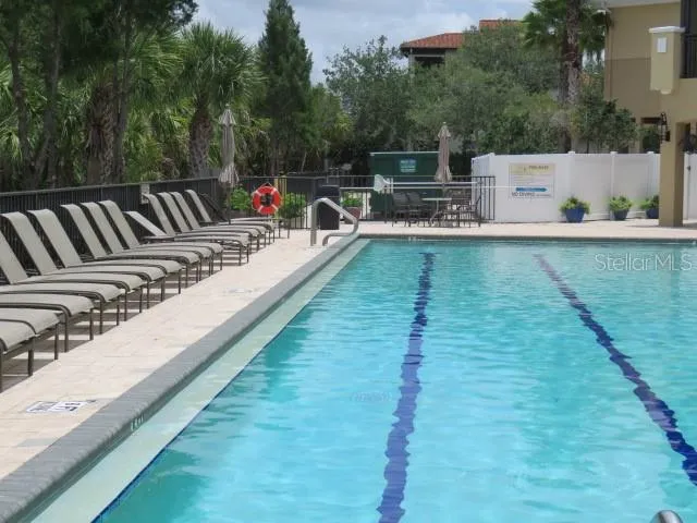a view of a house with swimming pool and a yard