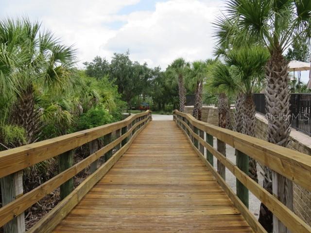 9720 Sea Turtle Terrace, Unit 201 Bradenton, FL 34212 - Photo 21 of 29 a view of balcony with wooden stairs and palm trees