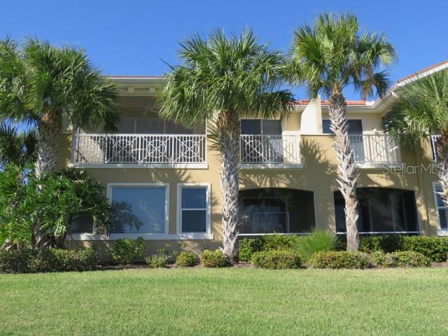 9720 Sea Turtle Terrace, Unit 201 Bradenton, FL 34212 - Photo 26 of 29 a front view of a house with a garden and plants