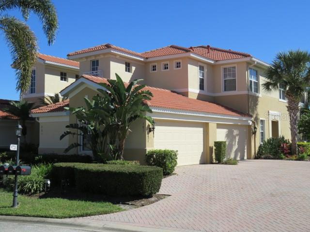 9720 Sea Turtle Terrace, Unit 201 Bradenton, FL 34212 - Photo 27 of 29 a front view of a house with a garden