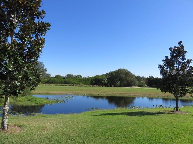 9720 Sea Turtle Terrace, Unit 201 Bradenton, FL 34212 - Photo 28 of 29 a view of a lake with houses in the background