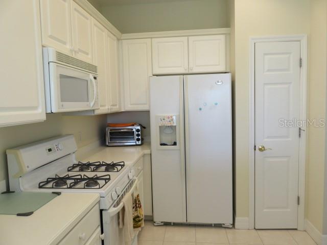 9720 Sea Turtle Terrace, Unit 201 Bradenton, FL 34212 - Photo 3 of 29 a kitchen with a stove and a refrigerator