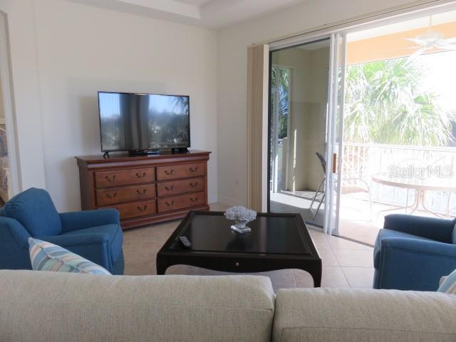 9720 Sea Turtle Terrace, Unit 201 Bradenton, FL 34212 - Photo 4 of 29 a living room with furniture and a flat screen tv