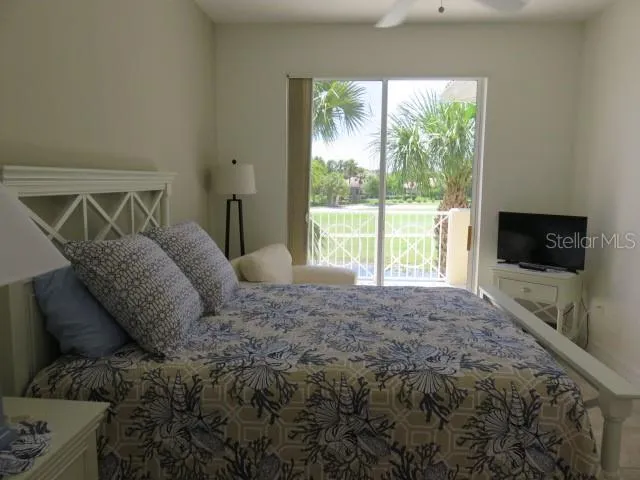 a large bed sitting in a bedroom next to a window