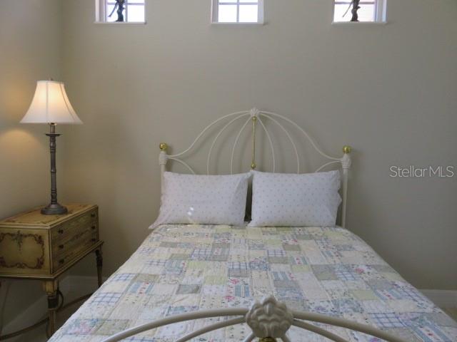 9720 Sea Turtle Terrace, Unit 201 Bradenton, FL 34212 - Photo 9 of 29 a bedroom with a bed and a lamp